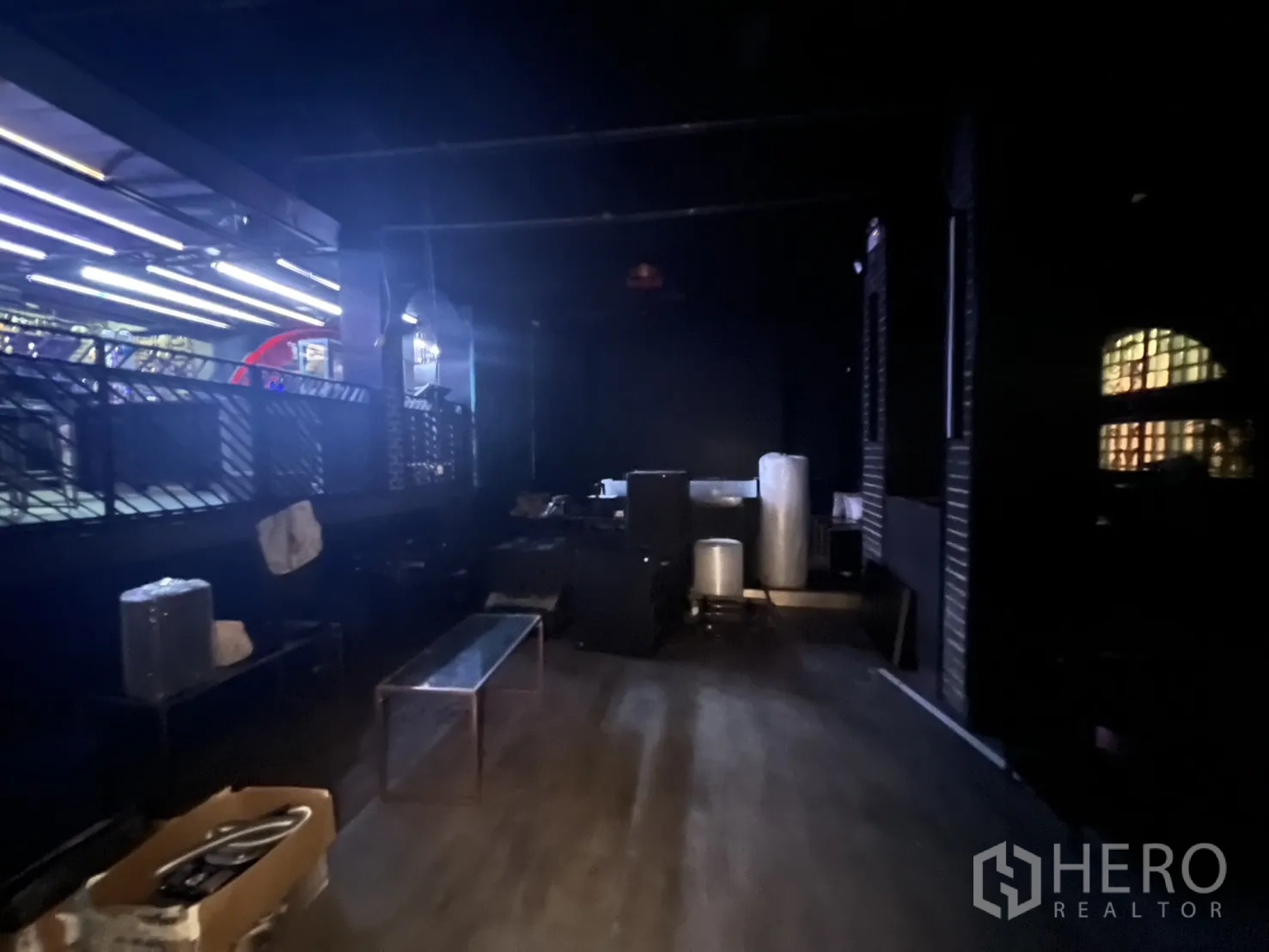 Retail Space for rent in Bangkok - Back room with mezzanine walkway, equipment and bench seating.
