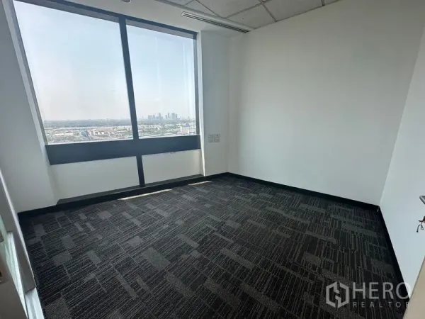 Office Space for rent in Khlong Toei, Bangkok - Bright office with panoramic city view through a wide window.