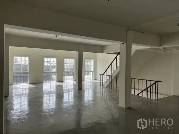 Factory for rent in Bang Sao Thong, Samut Prakan - Bright upper-floor office space with large windows and an internal staircase.