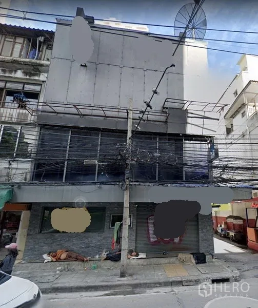 店屋 出租在Khlong Toei, Bangkok - 曼谷空堤区临街多层商铺楼外立面，带卷闸门与招牌位