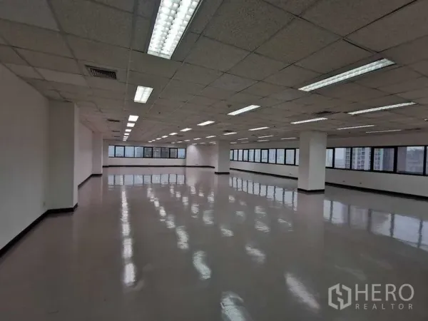 Office Space for rent in Watthana, Bangkok - Spacious open-plan office floor with polished floors, drop ceiling lights, and long ribbon windows offering city views.