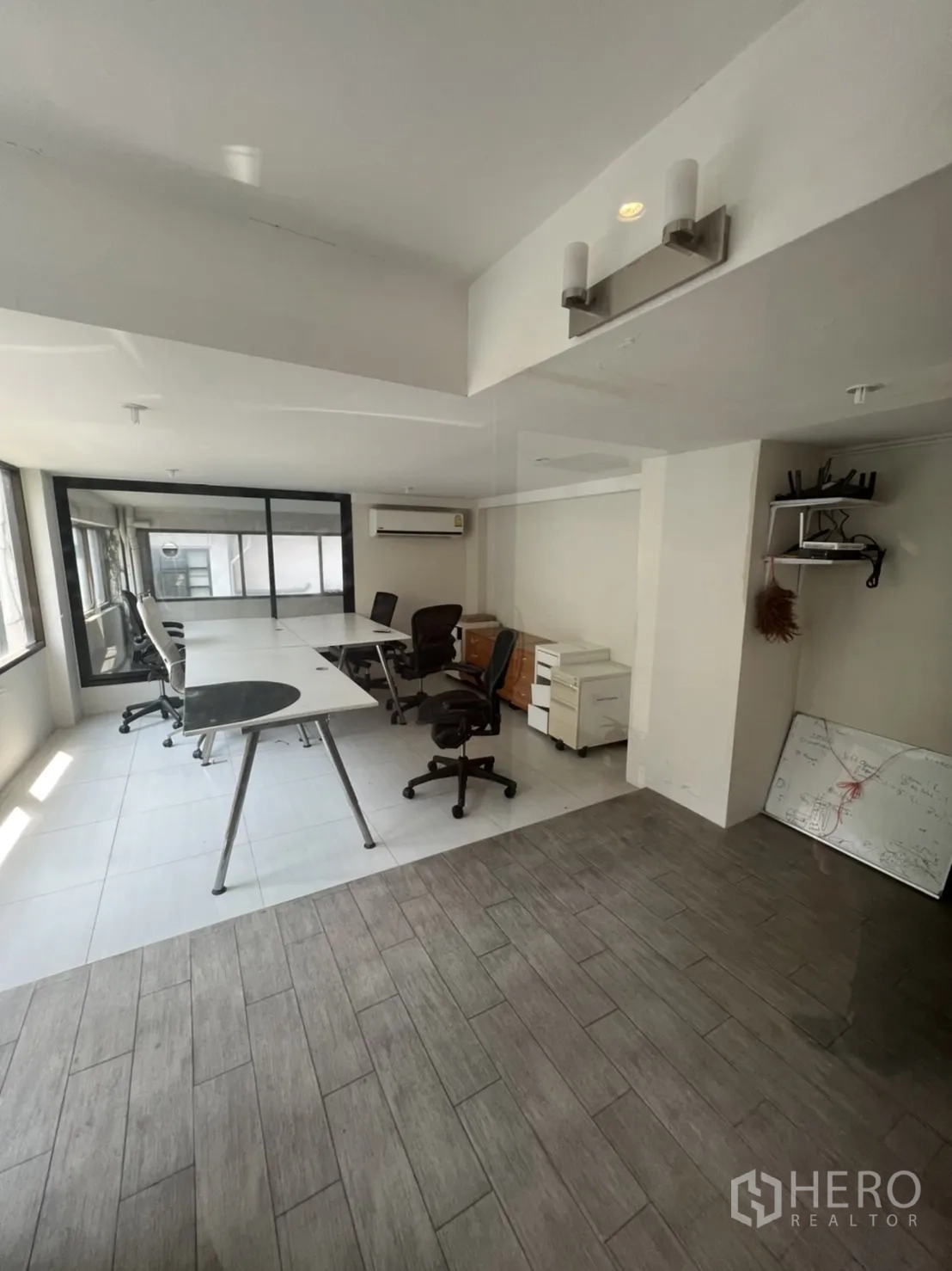 Retail Space for rent in Watthana, Bangkok - Open-plan office area with desks, chairs, split-type AC, and wood-look tiles.