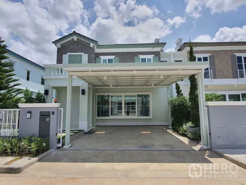 Townhouse for rent - Front view of a modern two-storey townhouse with a covered double carport and wide front windows.