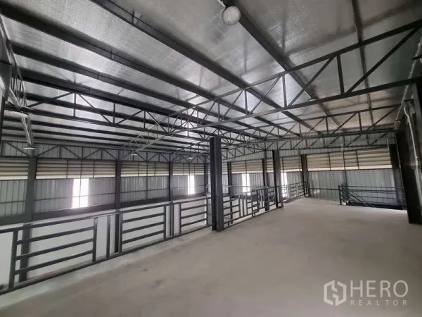 Warehouse for rent or sale in Bang Phli, Samut Prakan - Upper mezzanine level with steel trusses and safety railings for extra storage.