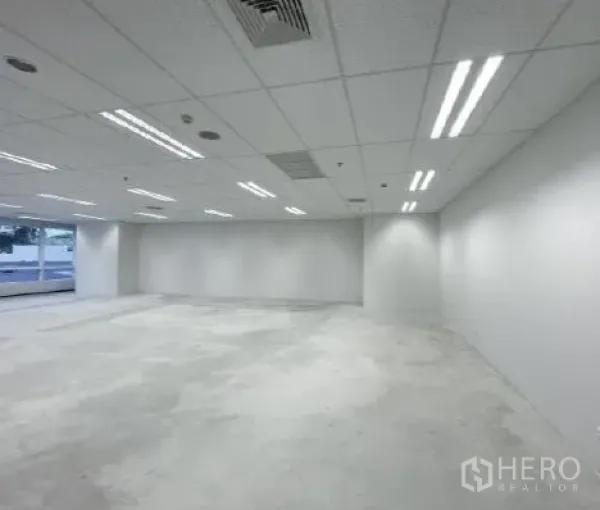 Office Space for rent - White-walled office floorplate with LED strip lights and flexible layout.
