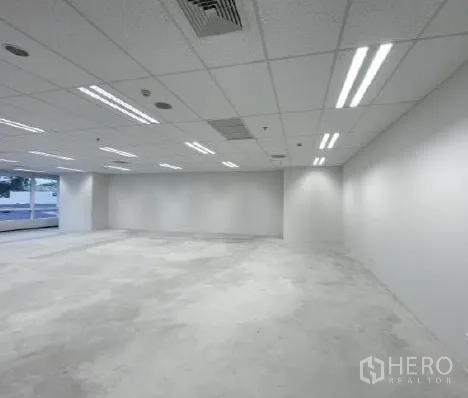 Office Space for rent - White-walled office floorplate with LED strip lights and flexible layout.