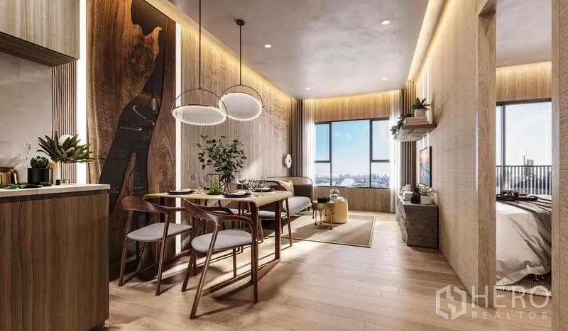 Condominium for sale in Khlong Toei, Bangkok - Open‑plan living and dining area with kitchenette, wood finishes and large windows.