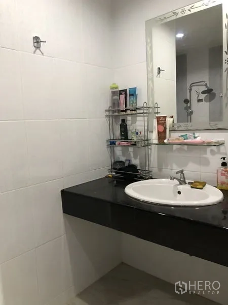 Detached House for sale in Lam Luk Ka, Pathum Thani - Bathroom vanity with sink, mirror and storage shelves.