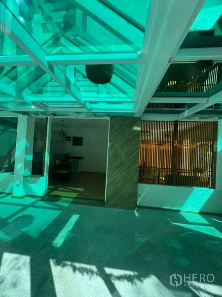 Retail Space for rent in Watthana, Bangkok - Sunlit covered patio under a green-tinted canopy leading into the shop interior