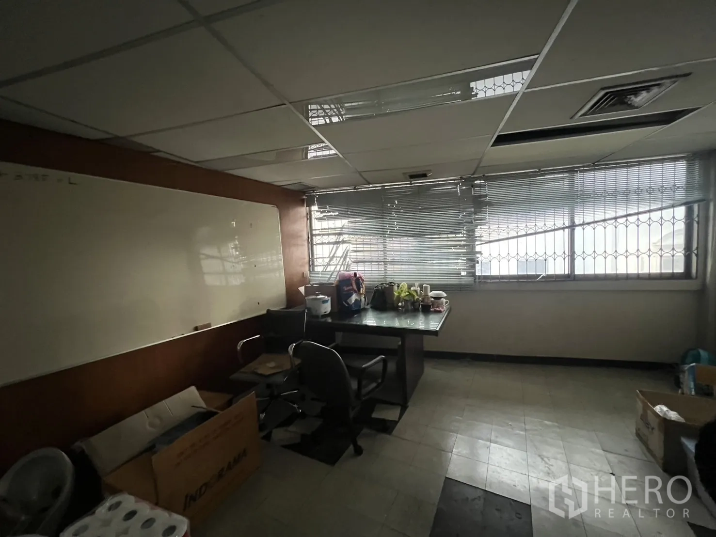 Shophouse for rent - Small meeting room with long table, whiteboard and window blinds.
