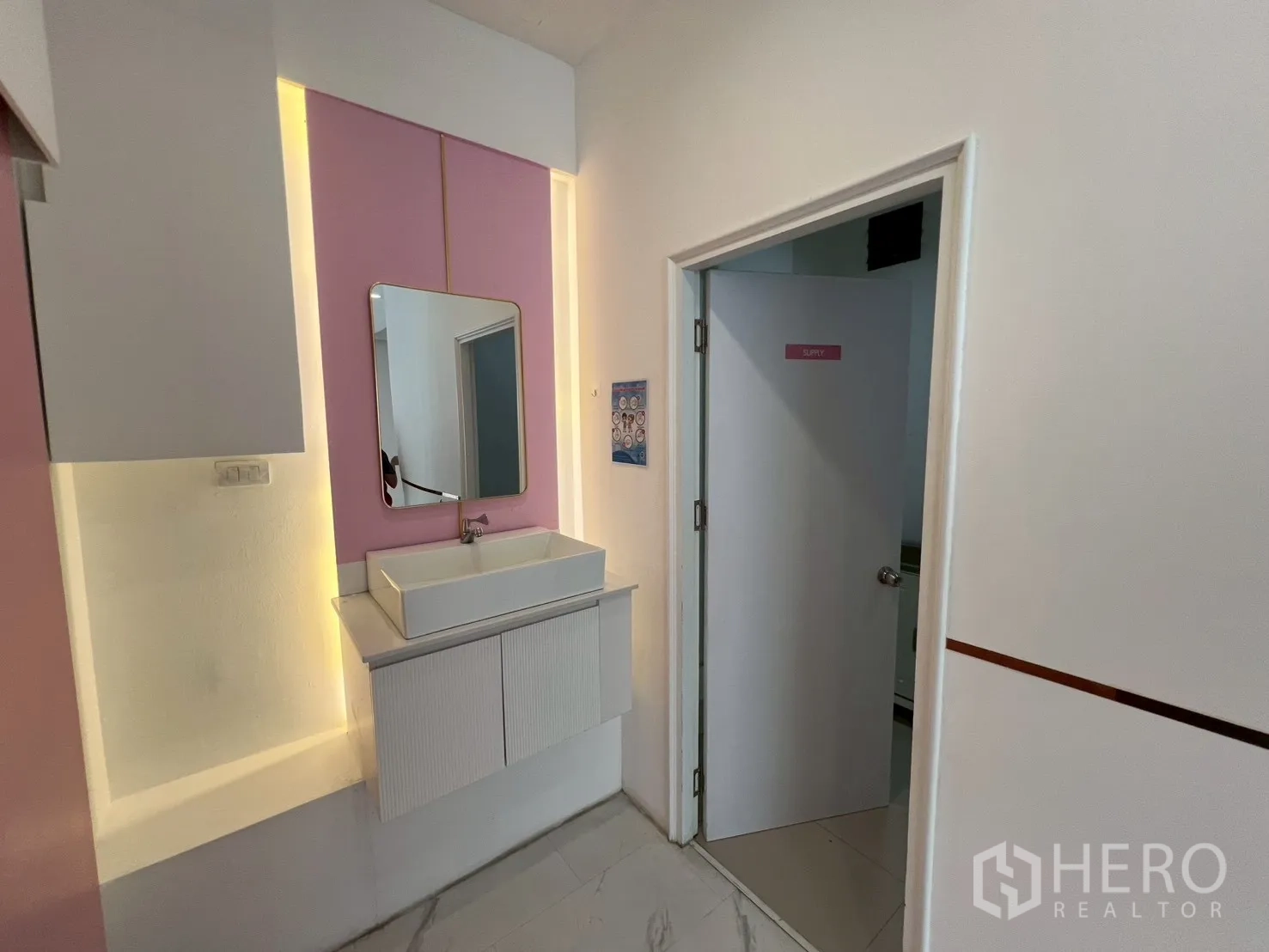 Retail Space for rent in Watthana, Bangkok - Vanity sink with mirror and pink panel beside a service room door.