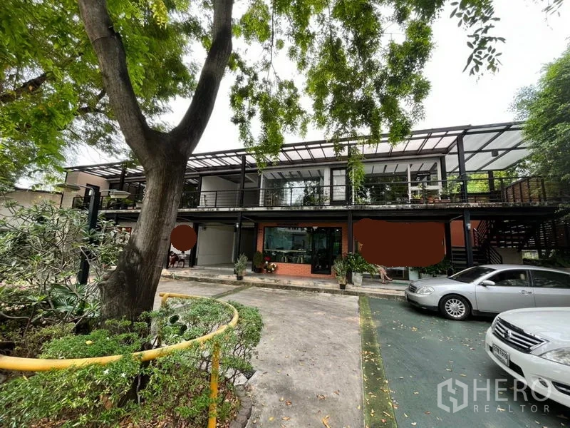 Retail Space for rent in Watthana, Bangkok - Two-storey modern retail complex with glass frontage, covered walkways, mature trees and on-site parking in Watthana, Bangkok.