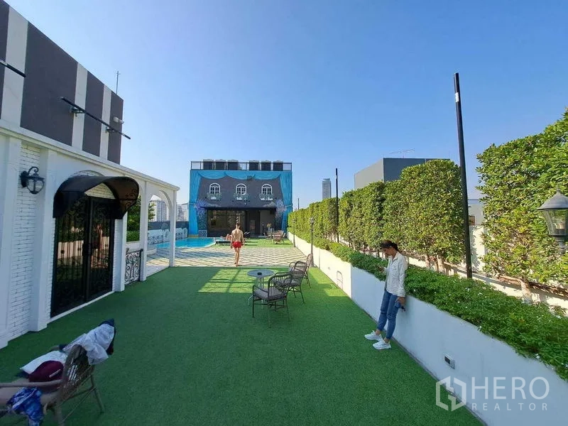 Retail Space for rent in Watthana, Bangkok - Long terrace bordered by hedges connecting the lawn to a poolside pavilion.