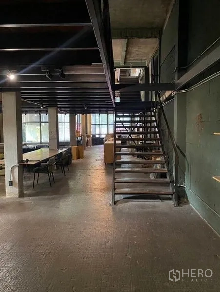 Retail Space for rent in Bang Na, Bangkok - Metal staircase under the mezzanine with worktable and seating area.