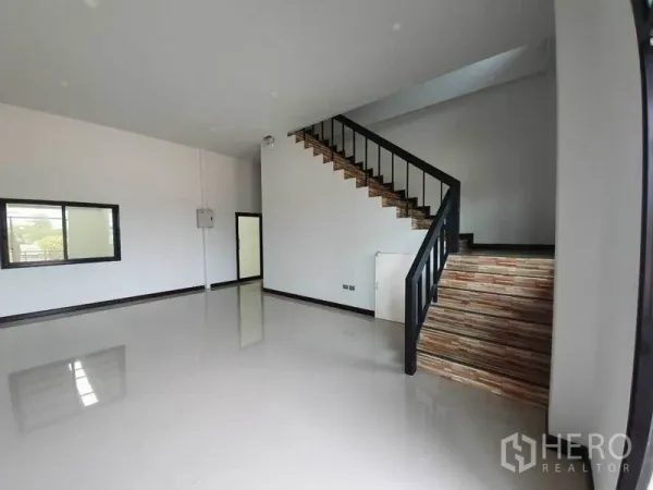 Factory for rent in Mueang Samut Sakhon, Samut Sakhon - Bright office area inside the factory with glossy tile flooring and a wood staircase to an upper workspace.
