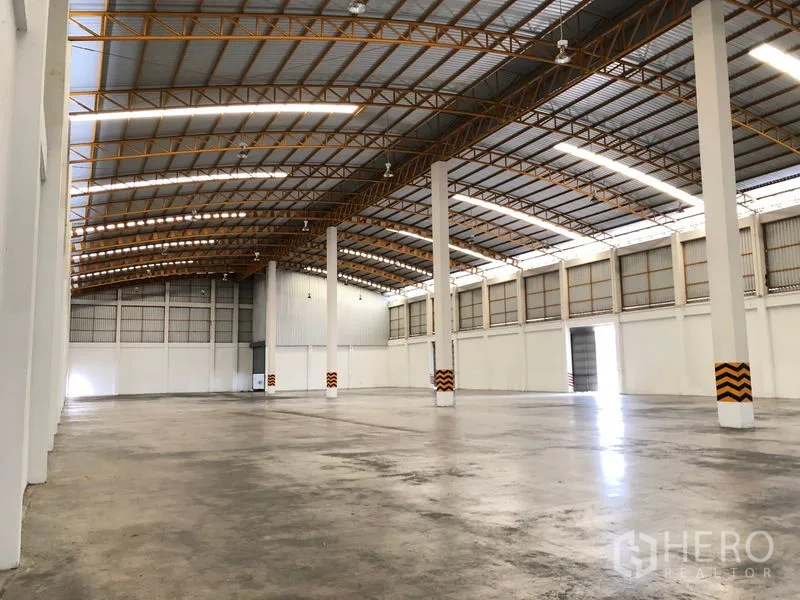 Warehouse for rent in Phra Nakhon Si Ayutthaya - Spacious clear-span warehouse interior with high steel roof and polished concrete floor.