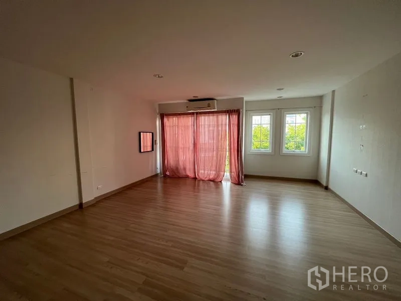 Home Office for rent or sale - Large bedroom or workspace with wood floor, pink curtains, air conditioner and twin windows.