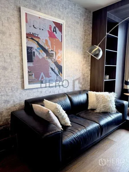Condominium for rent - Close view of the sofa, abstract wall art and shelving in the condo living room.