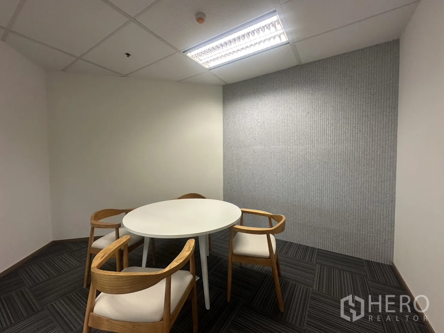 Office Space for rent in Pathum Wan, Bangkok - Enclosed meeting room with a round table and wooden chairs.