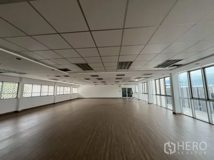 Office Space for rent in Watthana, Bangkok - Bright open workspace with grid ceiling, air vents and floor-to-ceiling windows.
