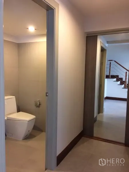 Detached House for rent or sale in Khan Na Yao, Bangkok - Hallway with separate toilet room and view toward stairs and living area