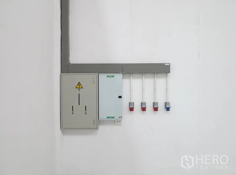 Warehouse for rent in Lopburi - Industrial electrical control panel with multiple power outlets mounted on a white wall