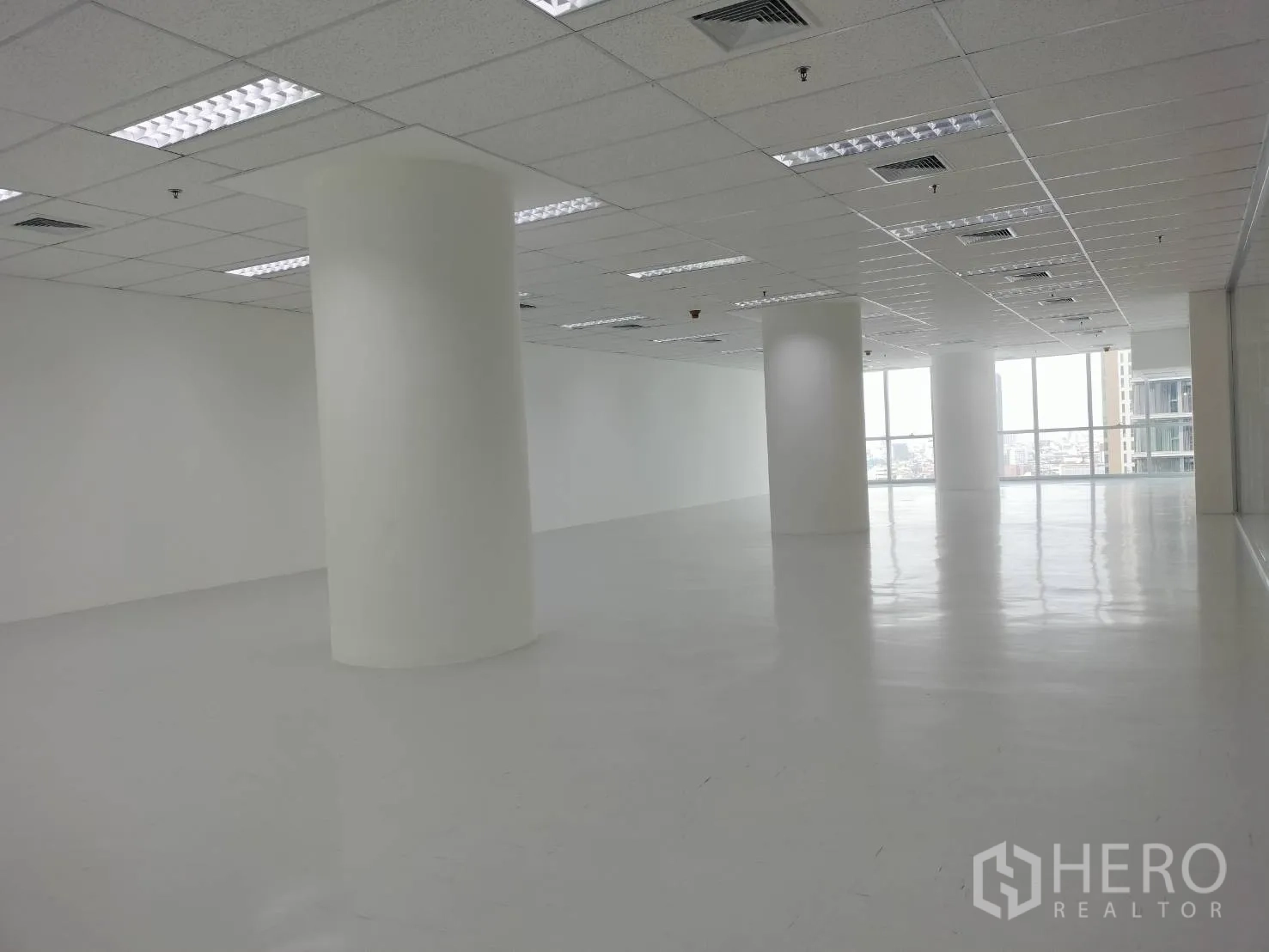 Retail Space for rent in Sathon, Bangkok - Open retail space with circular columns and floor-to-ceiling windows with city views.