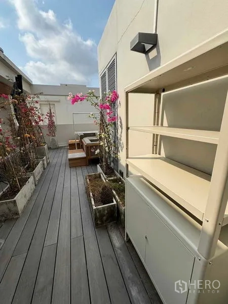 Townhouse for rent in Watthana, Bangkok - Rooftop walkway with planter boxes, decking and a built-in storage shelf.