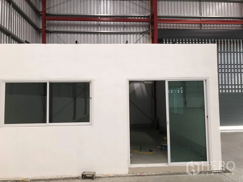 Warehouse for rent in Pak Kret, Nonthaburi - Internal office room with sliding glass door and windows inside the warehouse.