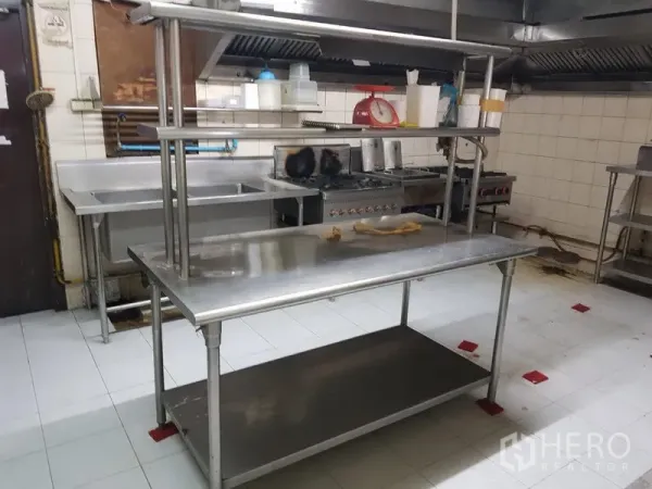 Retail Space for rent in Watthana, Bangkok - Fitted commercial kitchen with stainless worktables, sinks, and ventilation hood.