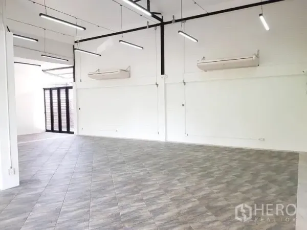 Office Space for rent in Chatuchak, Bangkok - Open office area with linear LED lighting, white walls, and air-conditioning units.
