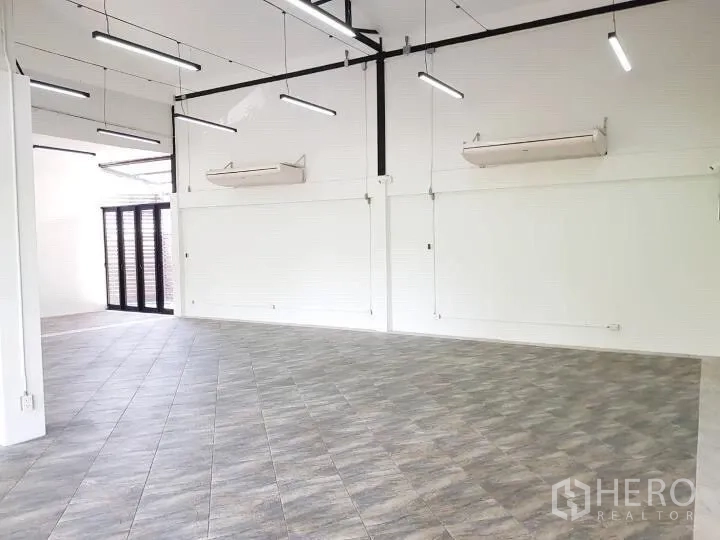 Office Space for rent in Chatuchak, Bangkok - Open office area with linear LED lighting, white walls, and air-conditioning units.