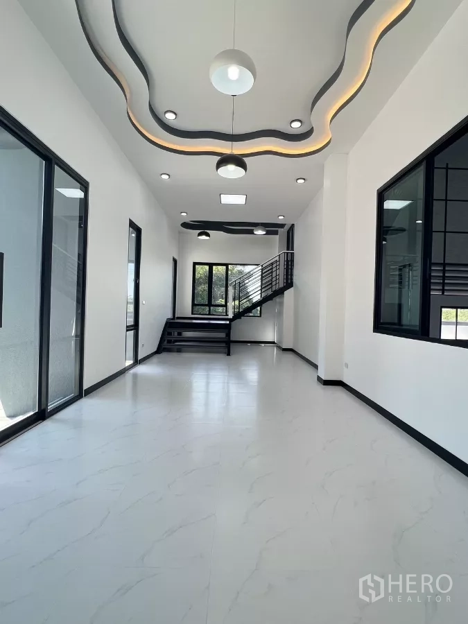 Warehouse for sale in Lam Luk Ka, Pathum Thani - Front office area with sculpted feature ceiling, pendant lights and stair to upper level.