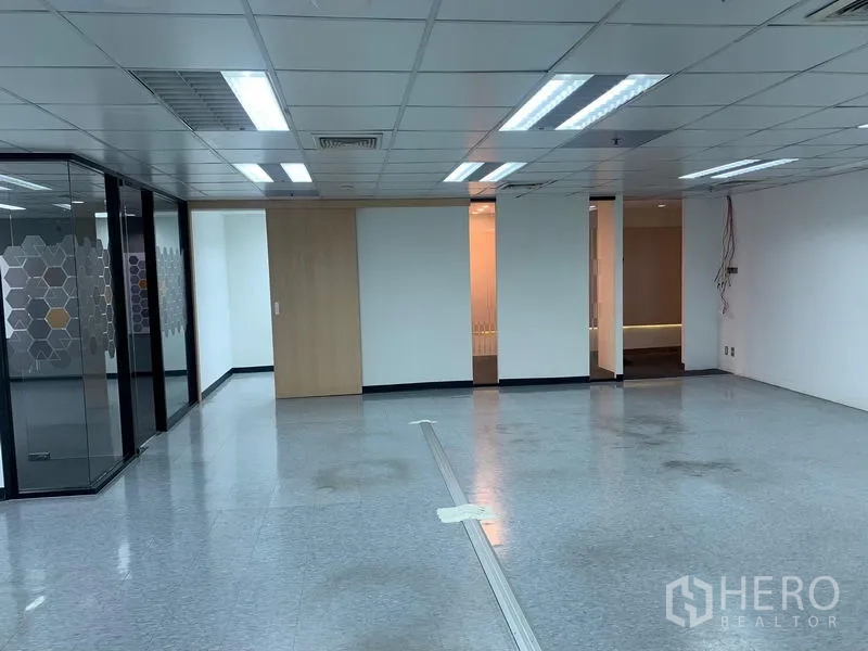 Office Space for rent in Bang Rak, Bangkok - Spacious open office with dropped ceiling lights and glass meeting rooms.