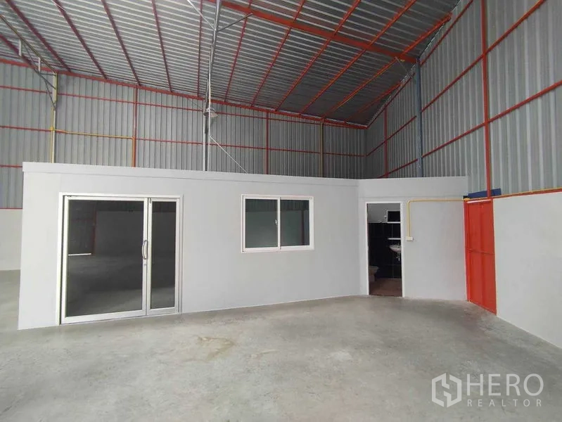 Warehouse for rent in Pak Kret, Nonthaburi - Built-in office unit inside the warehouse with sliding glass door and window.