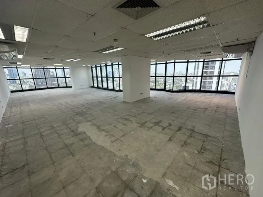 Office Space for rent - Spacious office unit with panoramic glazing on two sides, ducted air vents, and unfinished flooring ready for fit‑out.