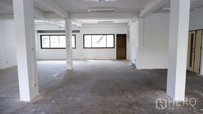 Office Space for rent in Watthana, Bangkok - Expansive workspace with a run of windows and two interior doors.