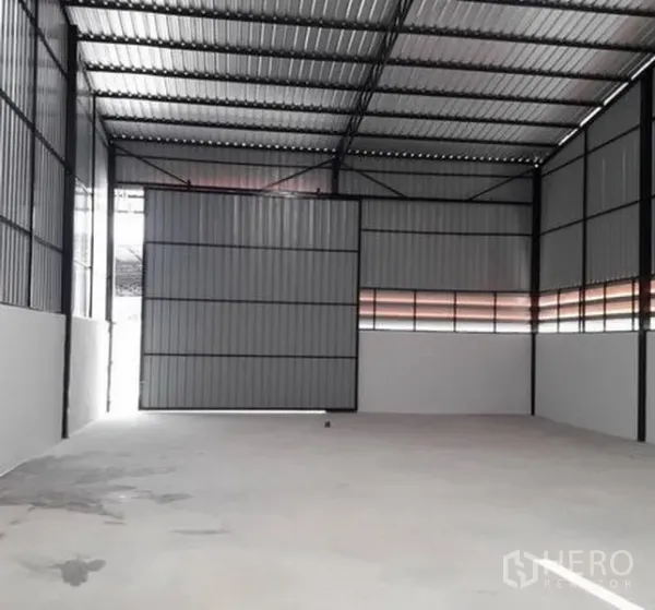 货栈 出租在Lam Luk Ka, Pathum Thani - 宽敞仓库，超高金属滑门半开，金属夹芯墙与混凝土地面。