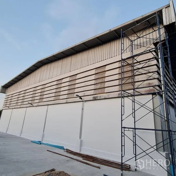 Warehouse for rent in Prawet, Bangkok - Warehouse side elevation with ventilation slats and exterior scaffolding.