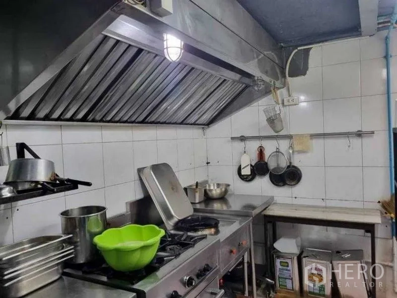 Retail Space for rent in Bang Rak, Bangkok - Gas range and exhaust hood in a tiled professional kitchen.