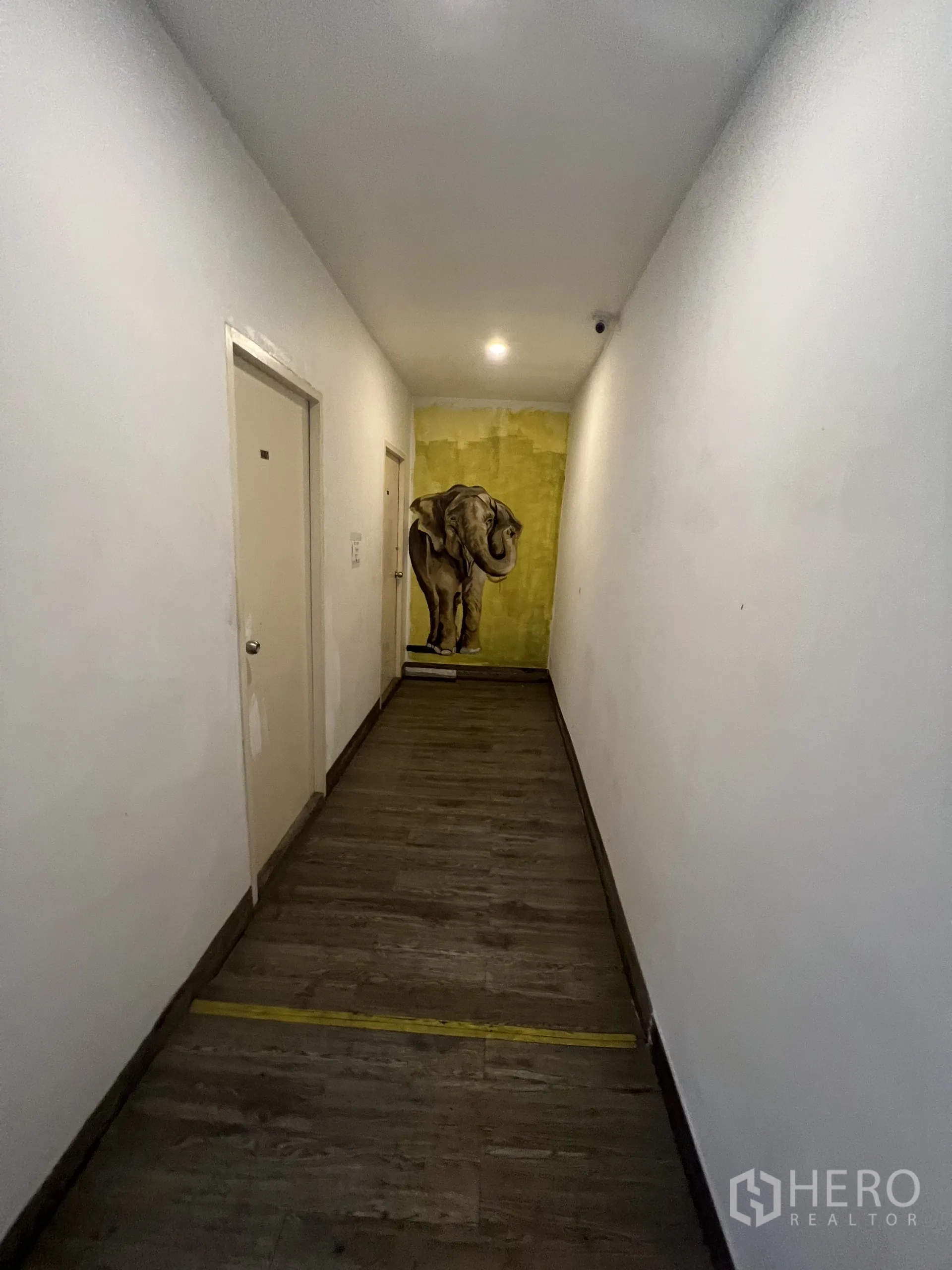 Shophouse for rent or sale in Watthana, Bangkok - Long indoor corridor leading to rooms, featuring an elephant mural at the end.
