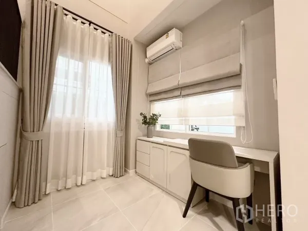 Detached House for rent in Bang Phli, Samut Prakan - Ground-floor study nook with built-in desk, air conditioner, and double curtains.