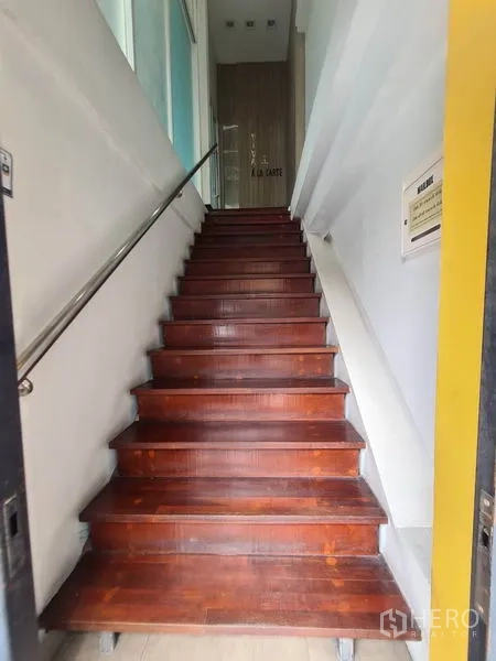 Retail Space for rent in Watthana, Bangkok - Entrance staircase with wooden steps and a metal handrail leading up.
