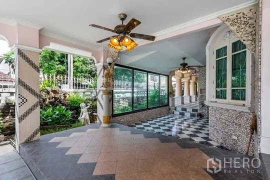 Detached House for rent or sale in Bang Khen, Bangkok - Covered terrace with ceiling fans, checkerboard floor, and garden outlook.