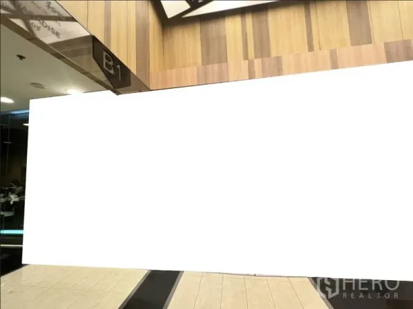 Retail Space for rent in Watthana, Bangkok - B1-level retail frontage with wood-paneled walls and tiled mall corridor.