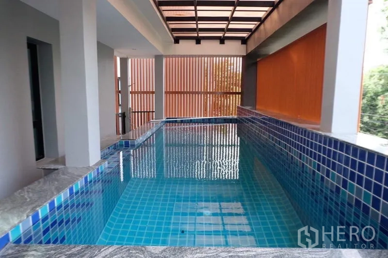 Detached House for sale in Bang Phli, Samut Prakan - Private indoor swimming pool with blue mosaic tiles under a roofed deck.