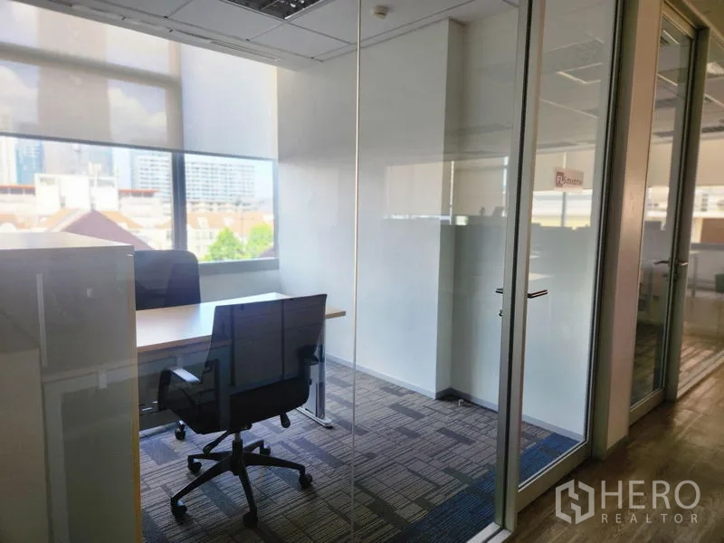 Office Space for rent in Watthana, Bangkok - Private glass office with single desk, ergonomic chair and skyline outlook.