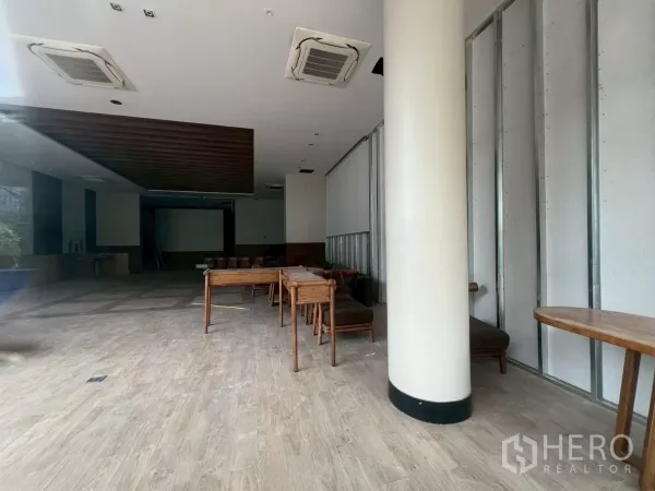 Retail Space for rent - Deep shop space featuring a wood-slat ceiling and projector wall, ready for fit-out.