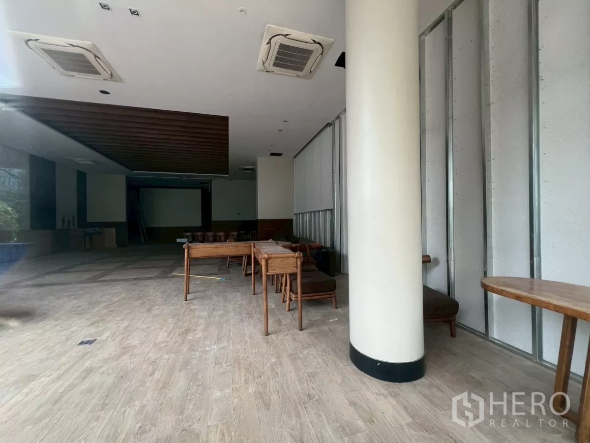 Retail Space for rent - Deep shop space featuring a wood-slat ceiling and projector wall, ready for fit-out.