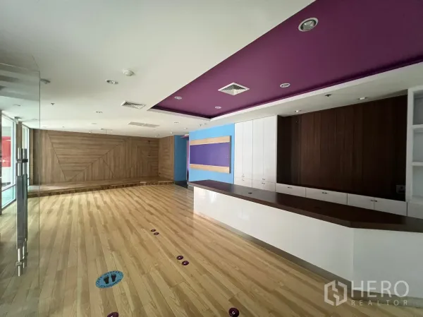 Retail Space for rent - Wide sales area with service counter, storage cabinets and recessed lighting over wood flooring.
